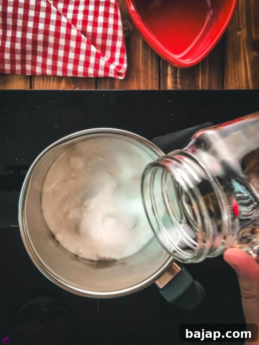 Saucepan with granulated sugar. Pouring water into the sauce pan.