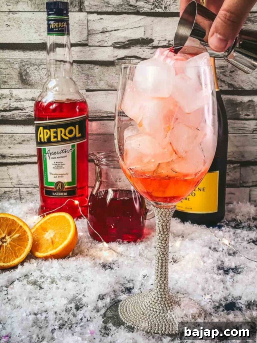 Add cranberry juice to the Aperol.