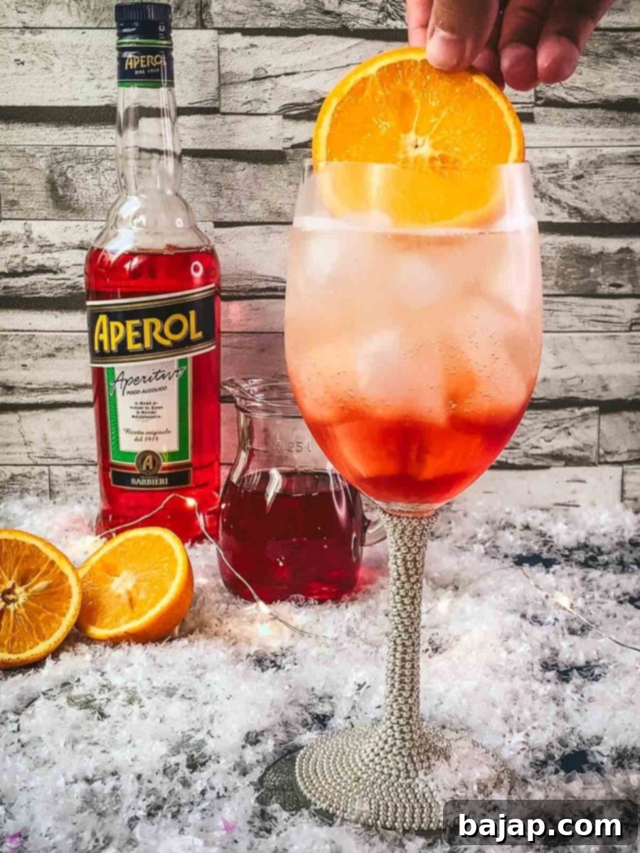 Garnish your Winter Aperol spritz with a orange slice.
