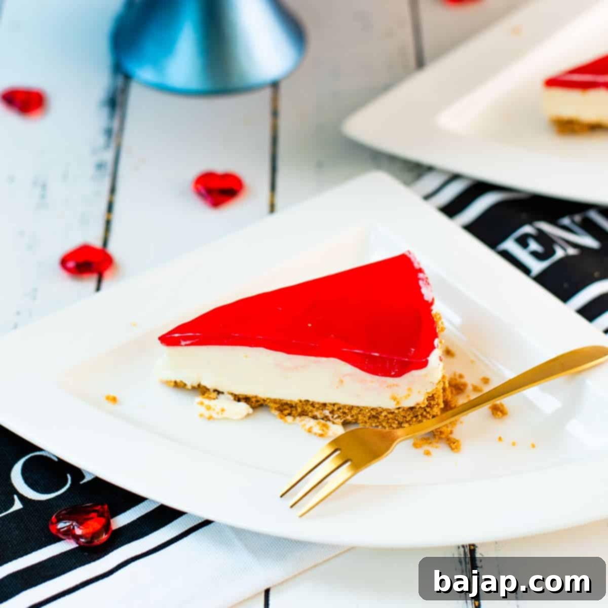 Cupid's Kitchen Valentine's Day Treats 5 A beautiful slice of no-bake lemon raspberry cheesecake, garnished with fresh raspberries and a golden fork, ready for a Valentine's celebration.