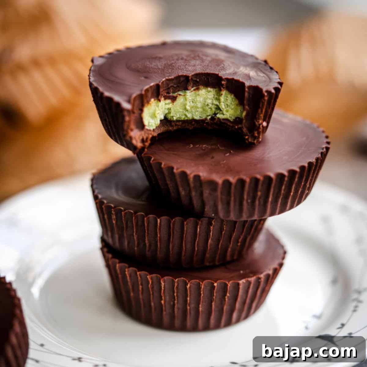 Decadent Matcha Dark Chocolate Mint Cups, stacked on a plate, offering a healthy and rich St. Patrick's Day treat.