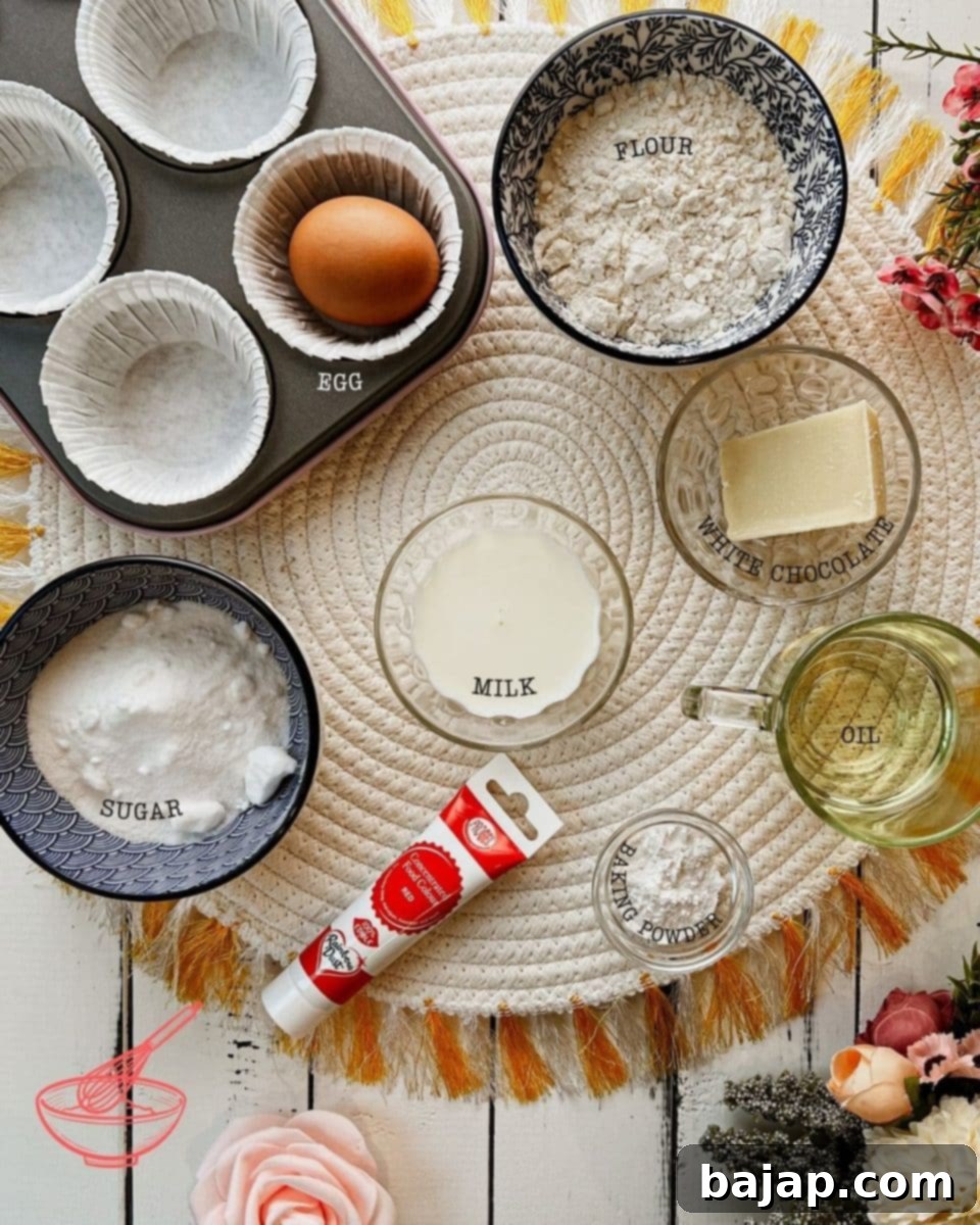 Assortment of fresh ingredients, including flour, sugar, eggs, oil, milk, and red food coloring, neatly arranged for making red velvet cupcakes.