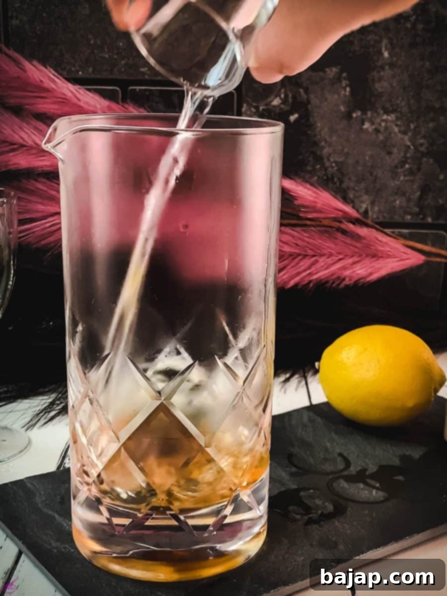 Add the specified amount of gin to the stirring glass, forming the spirit base of the Martinez.