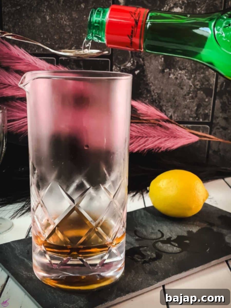 Measure and add one bar spoon of maraschino liqueur, providing a crucial fruity sweetness.