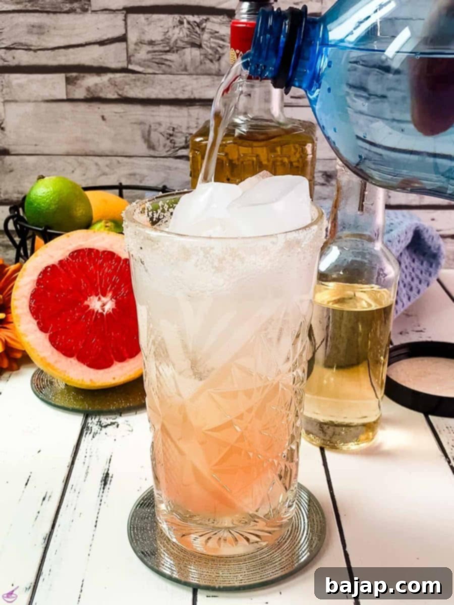 Top the assembled cocktail with soda water for a refreshing fizz and lightness.