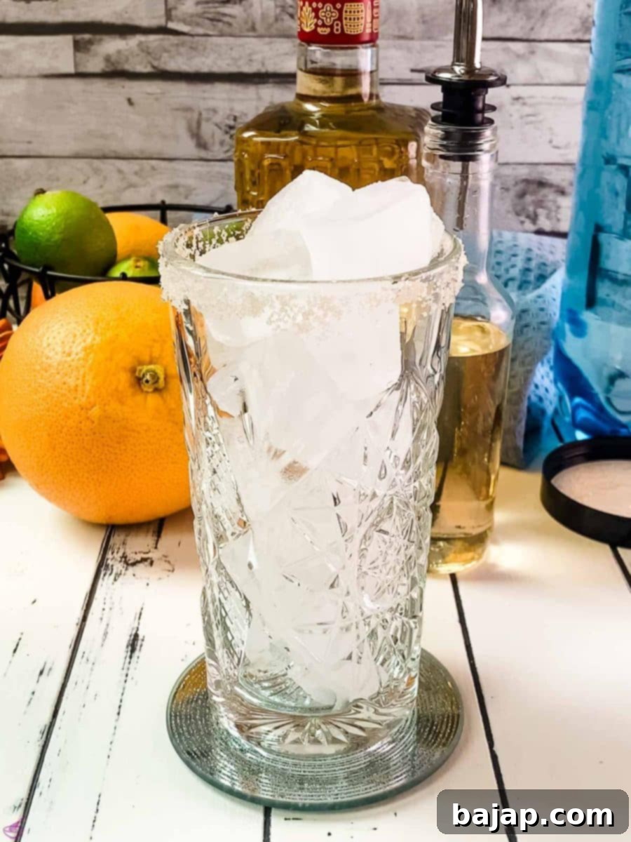 Fill the prepared highball glass to the brim with fresh cubed ice, ensuring a perfectly chilled Paloma.