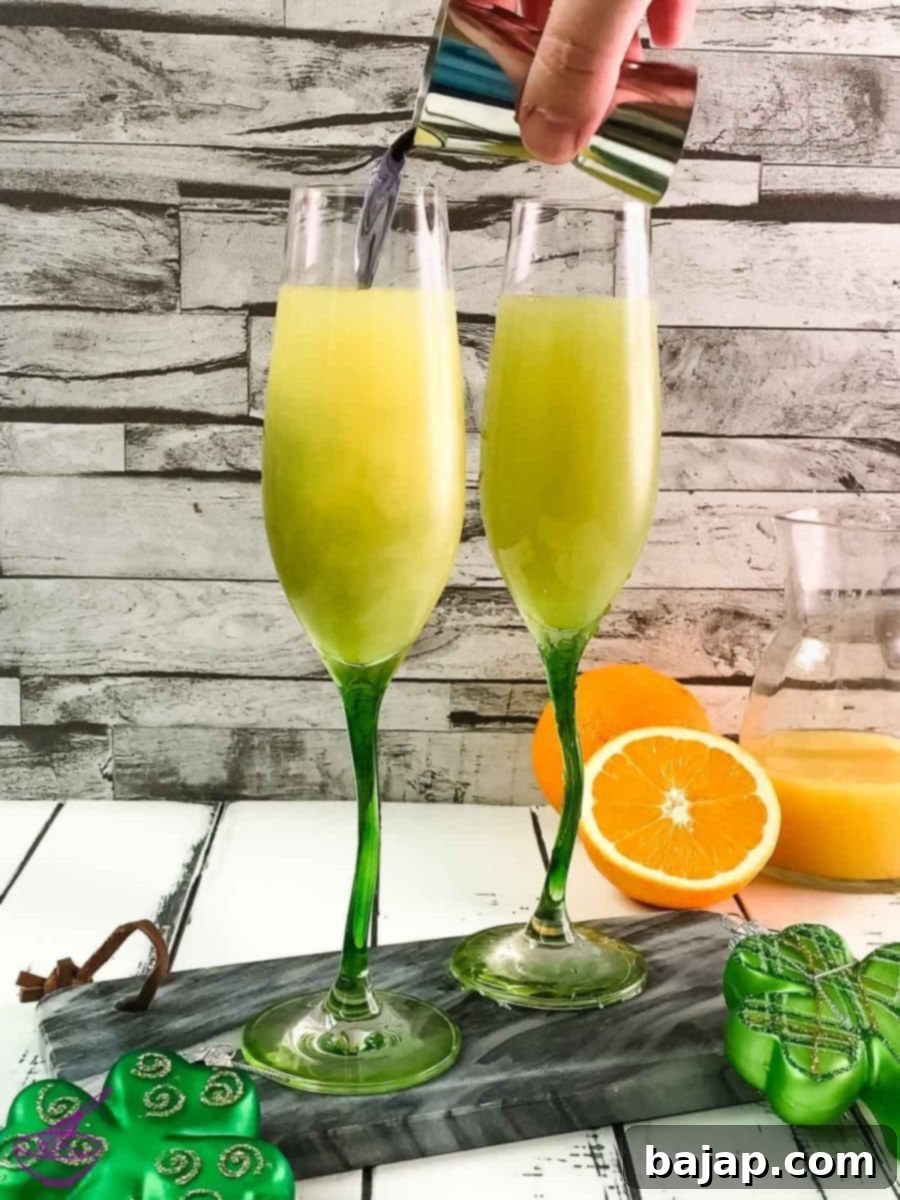 The final step is to add the violet liqueur to create the green color for your St. Patrick's Day Mimosa.