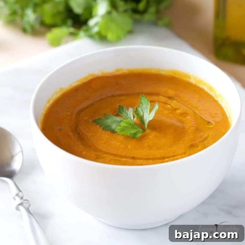 Healthy Carrot-Apple Soup is perfectly spiced with apple sauce, turmeric and cumin, sausages, and chicken stock. Super delicious, healthy, and low in carbs. (Paleo, Gluten-free, Whole30).
