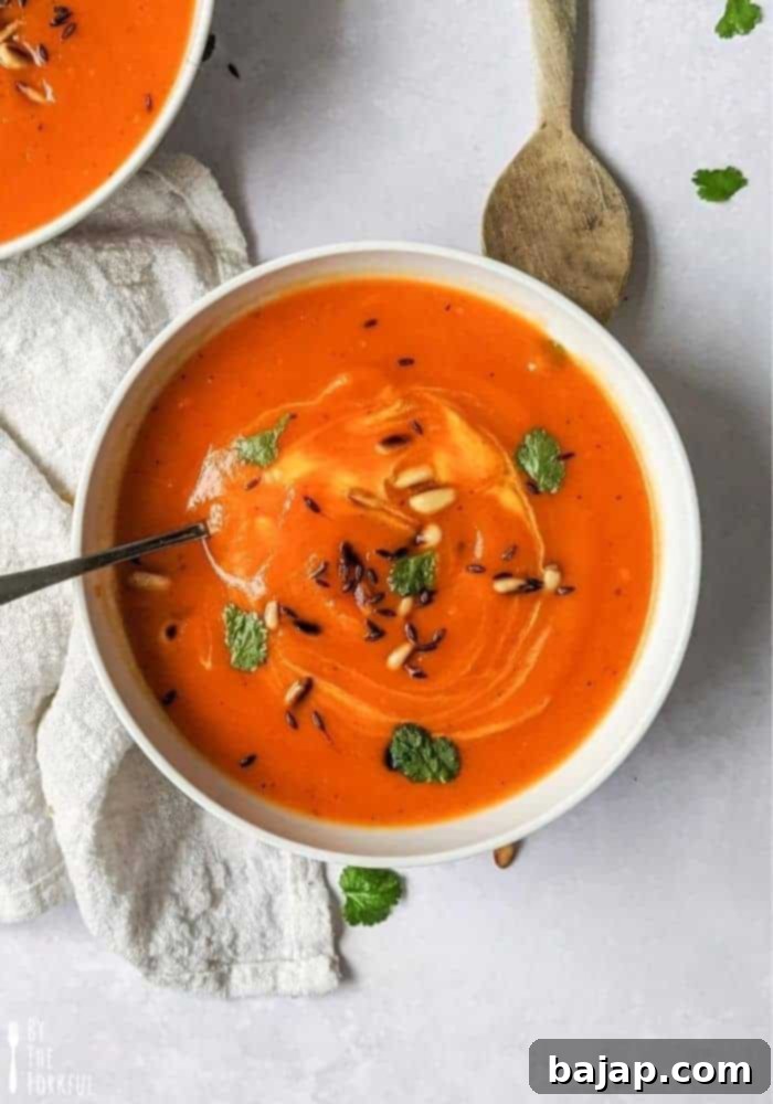 Creamy roasted red pepper and butternut squash soup made with minimal ingredients and finished with a kick of chili and toasted cumin seeds for extra flavor!