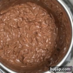 combine melted chocolate couverture and roasted almond slivers