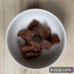 Melted chocolate couverture, smooth and glossy, ready for mixing