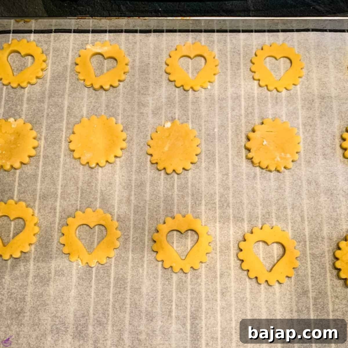 Egg Liqueur Infused Linzer Cookies 11 Arrange the cut-out Linzer cookies on a baking sheet lined with parchment paper, ready for baking.