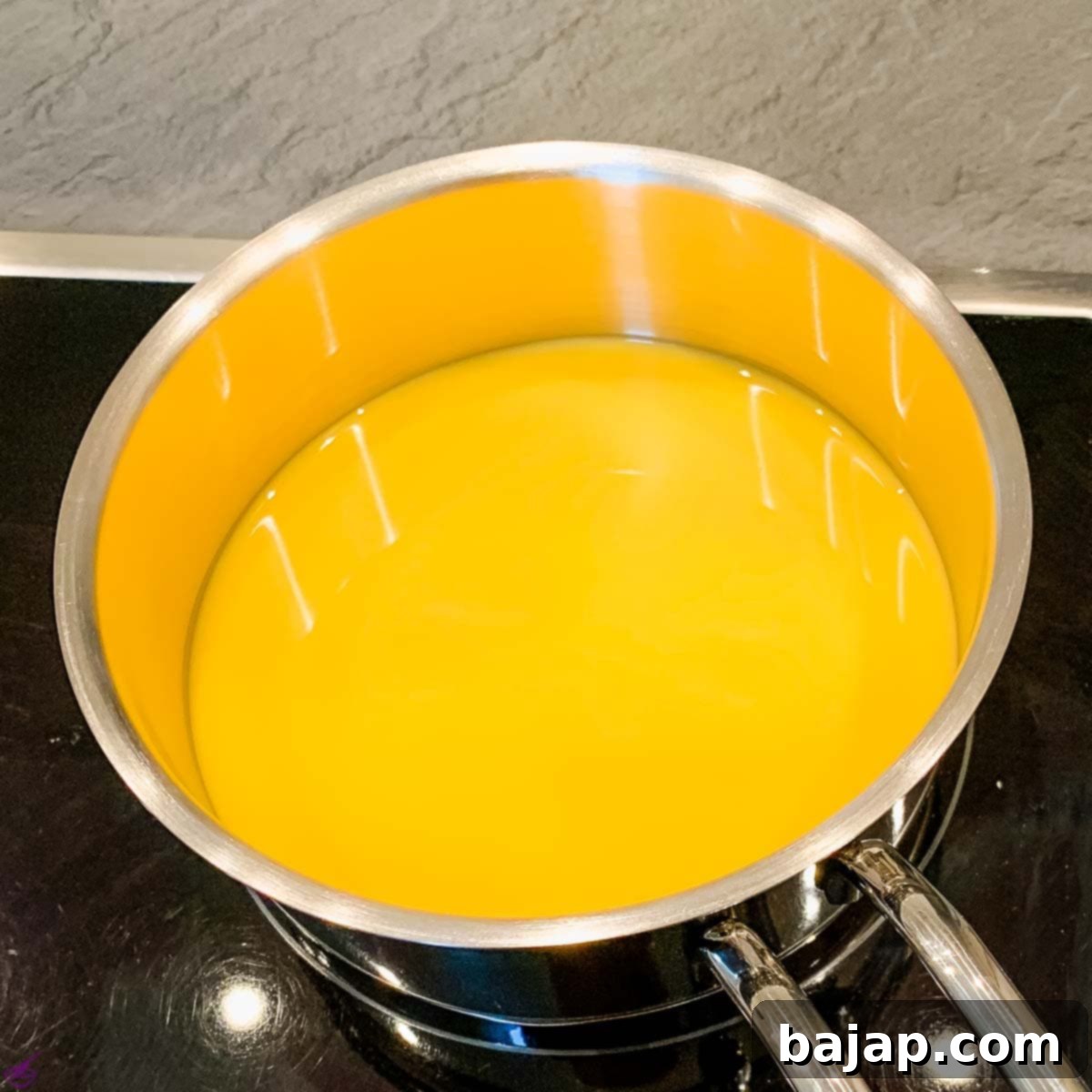 Warm up the eggnog in a saucepan, but do not boil it!