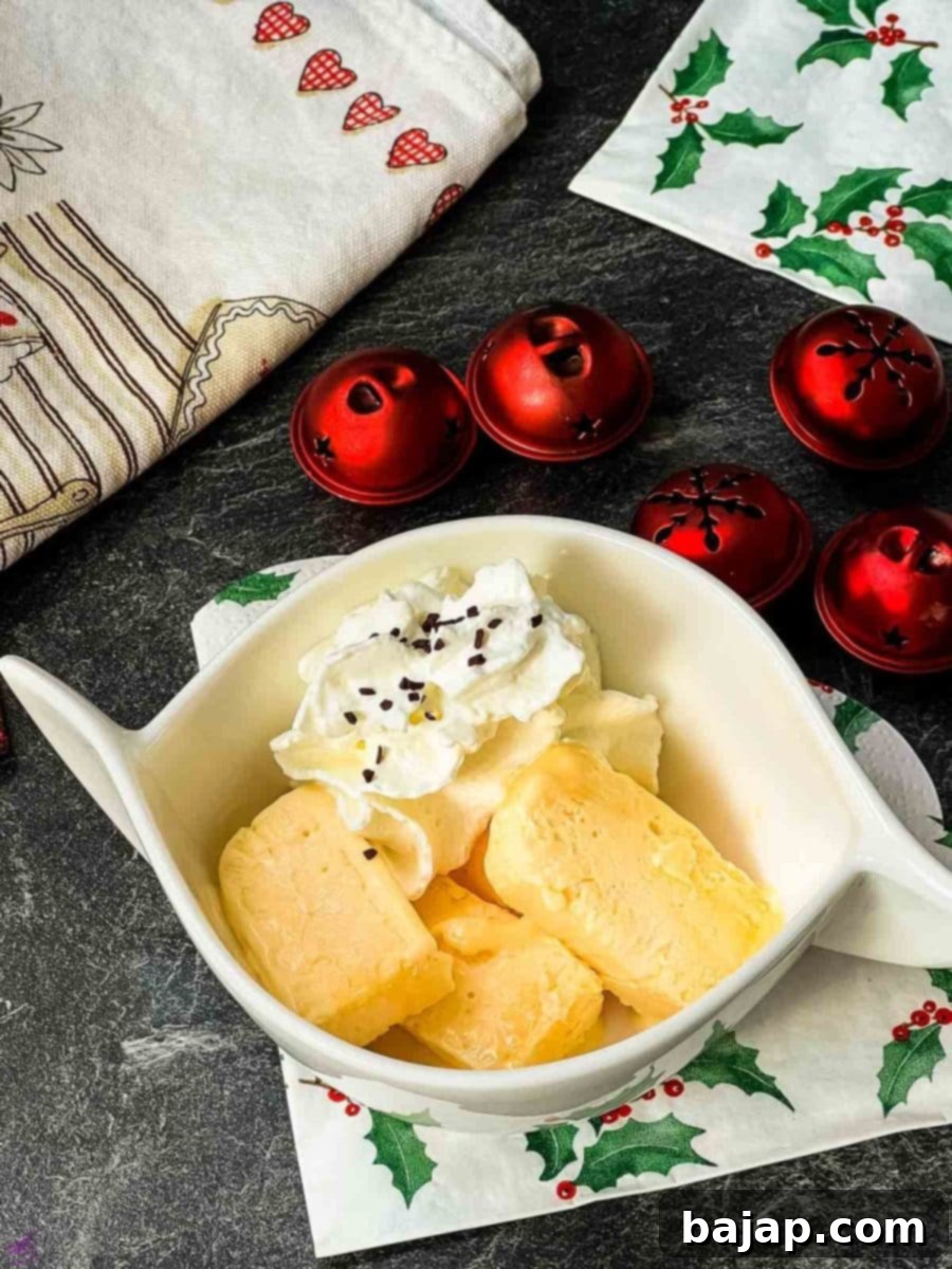 Delicious egg liqueur parfait in white bowl. Garnished with whipped cream and chocolate sprinkles.