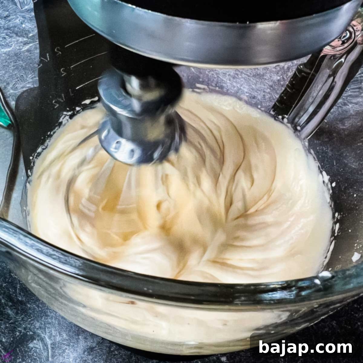 Add the egg liqueur to the yolks and sugar mixture.