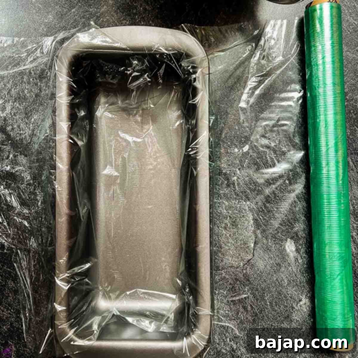 Cover the loaf pan with cling film.