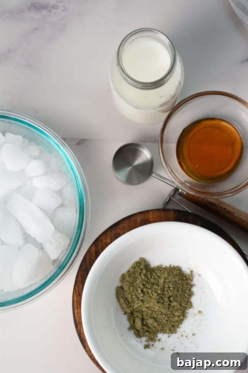 Ingredients for matcha oat milk latte, neatly arranged on a counter.