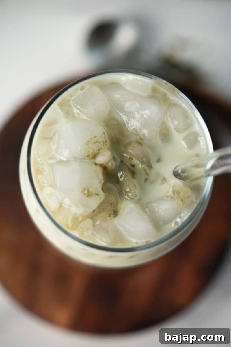 Overhead view of a glass filled with matcha oat milk latte.