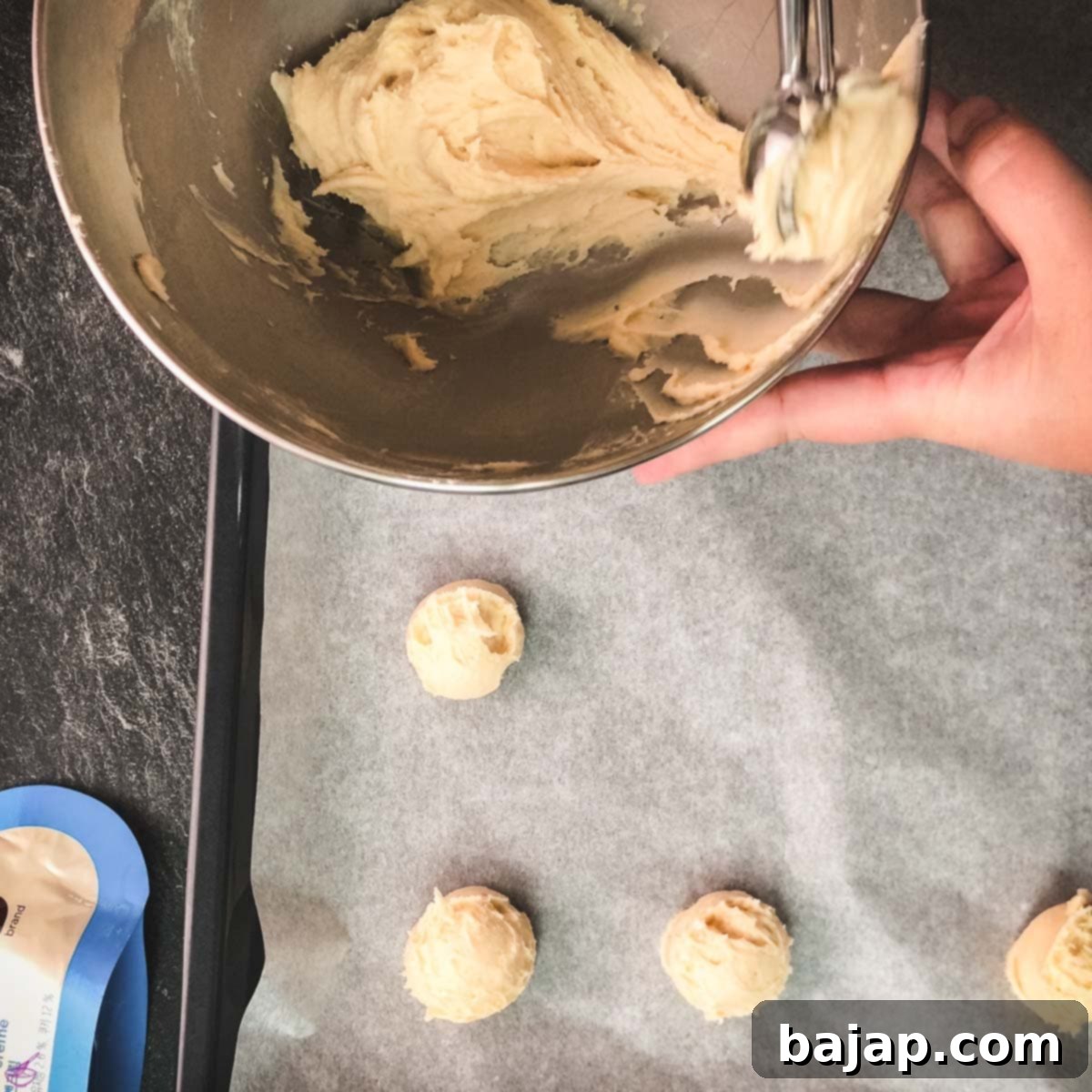 Scoop little balls out of the cookie dough and place them on a baking sheet lined with parchment paper.