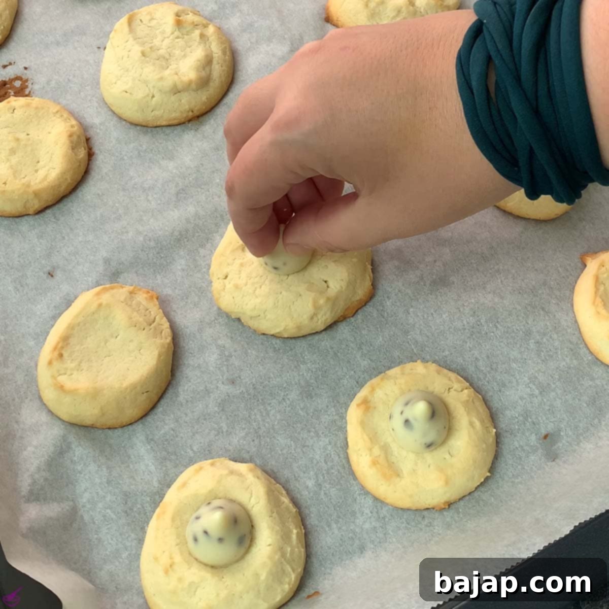Place the Hershey cookies and cream kisses on top of the hot cookie.