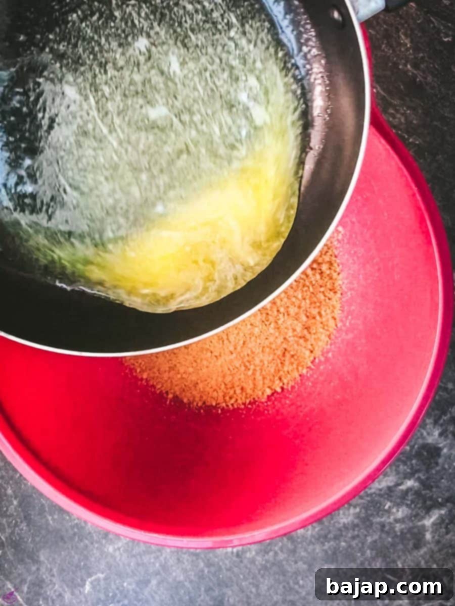 Pour the melted butter over the cracker crumbs and mix well.