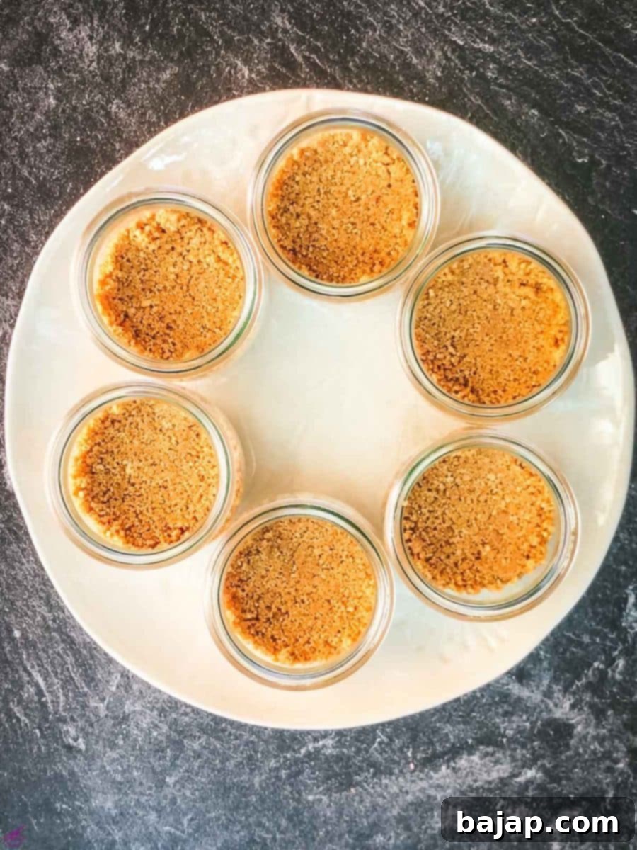 Preserving jars filled with a graham cracker base.