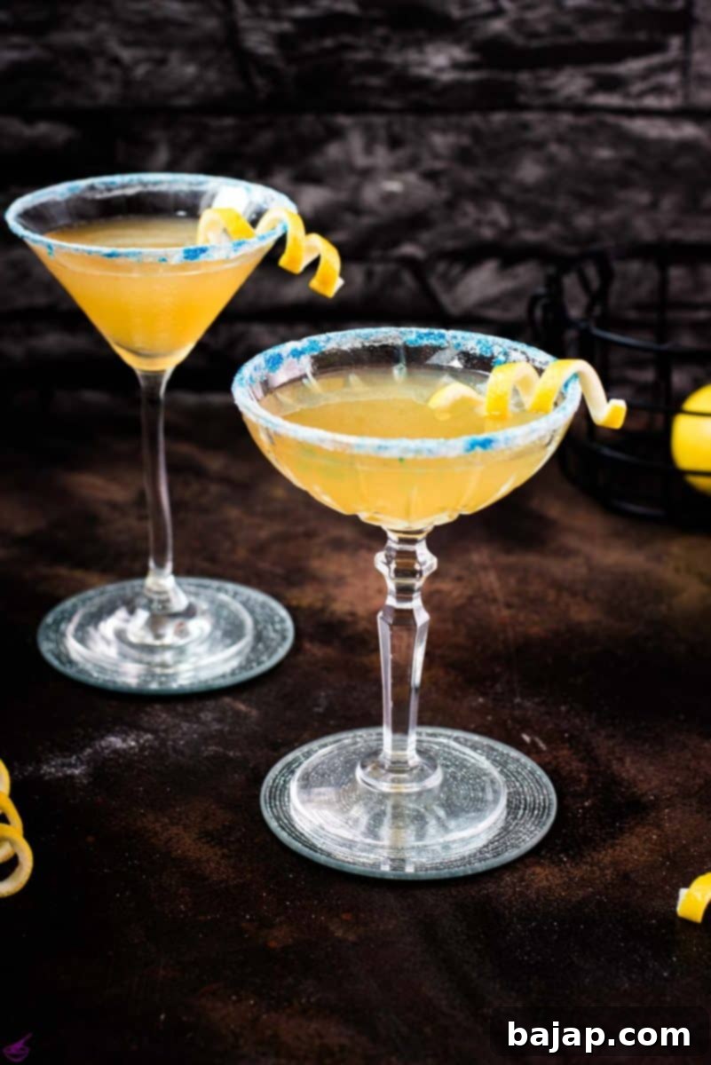 Lemon-Kissed Whiskey Sidecar 2 A perfectly crafted Whiskey Sidecar cocktail with a vibrant lemon twist and a beautiful blue glitter sugar rim, presented in a coupe glass.