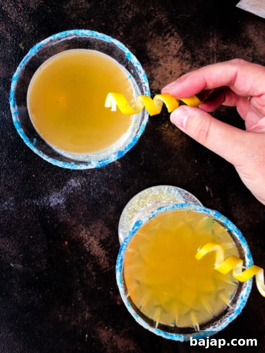 Lemon-Kissed Whiskey Sidecar 13 Garnishing the Whiskey Sidecar with a fresh lemon twist just before serving.