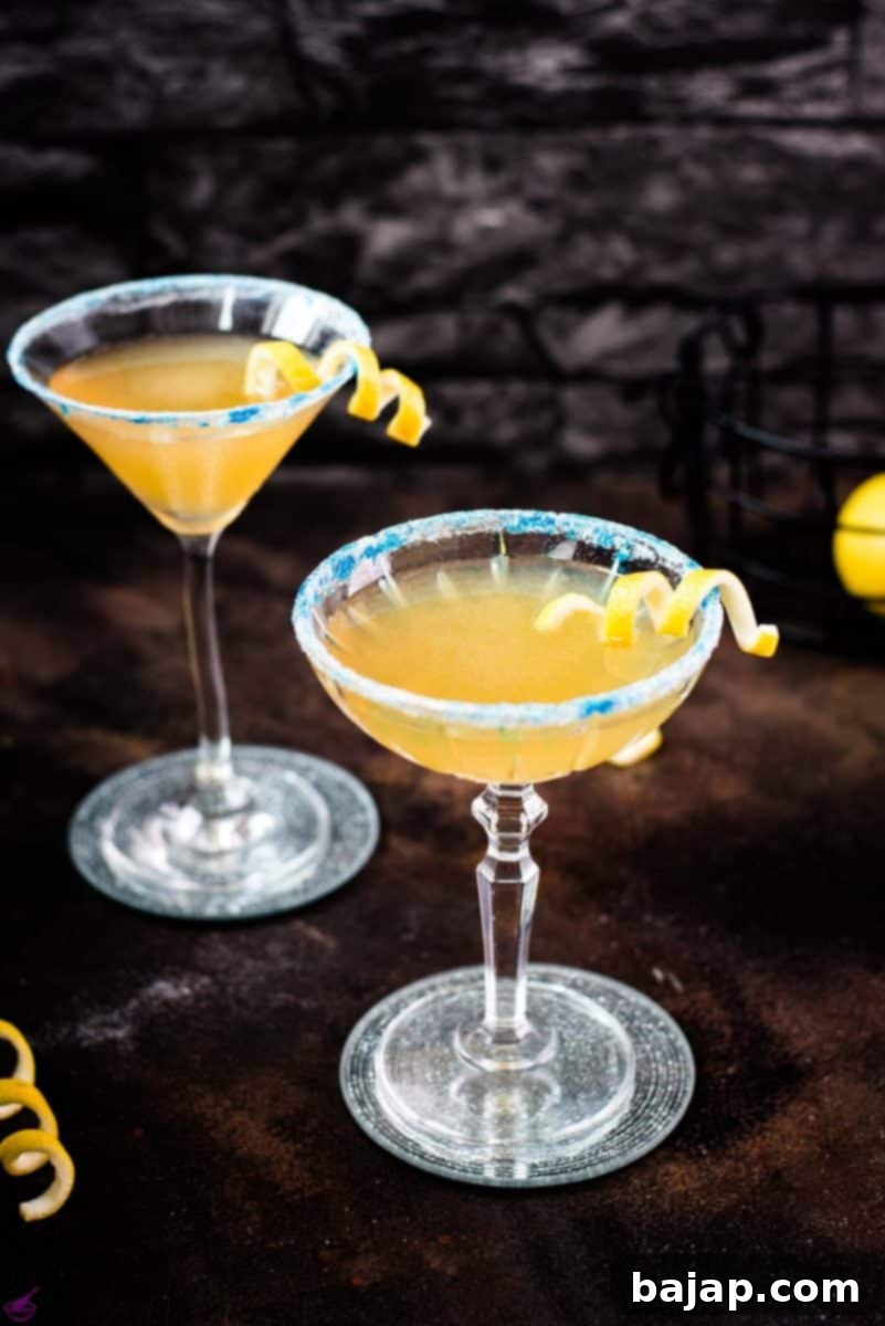 Lemon-Kissed Whiskey Sidecar 15 A beautifully presented Whiskey Sidecar cocktail with a sparkling blue sugar rim and a fresh lemon twist.