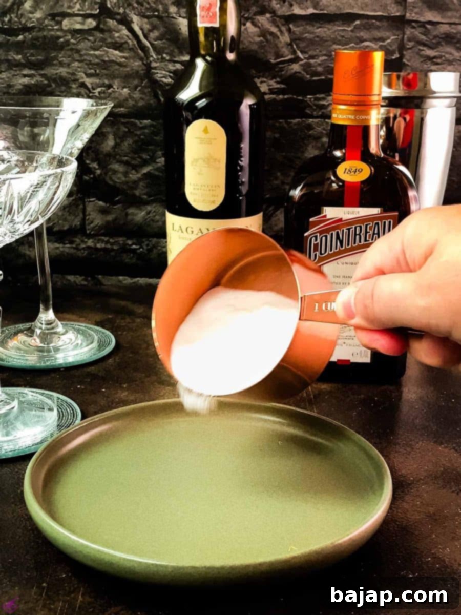 Adding superfine sugar onto a plate for the cocktail rim.
