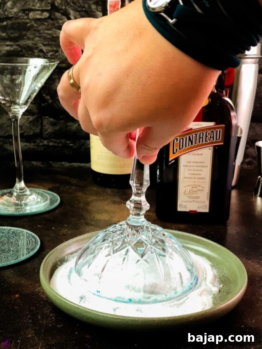 Lemon-Kissed Whiskey Sidecar 8 Coating the rim of the cocktail glass with the blue-colored superfine sugar mixture.