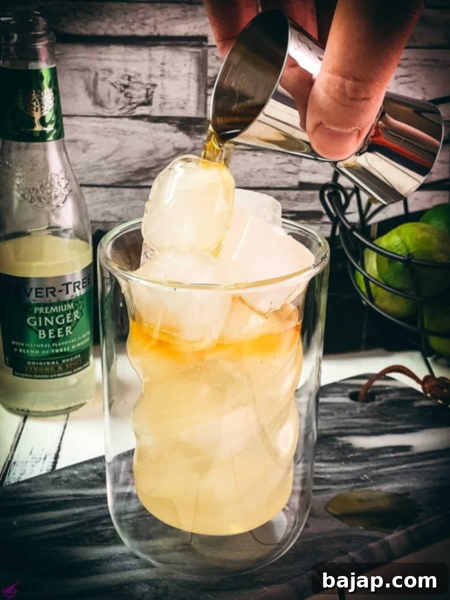Carefully add the dark rum last to create layers.