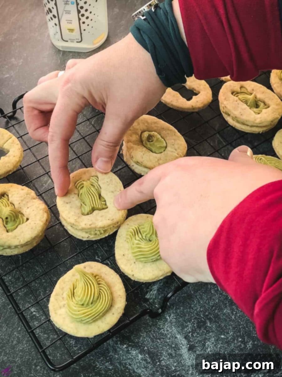 Carefully place the cut-out motif cookie on top of the pistachio ganache.