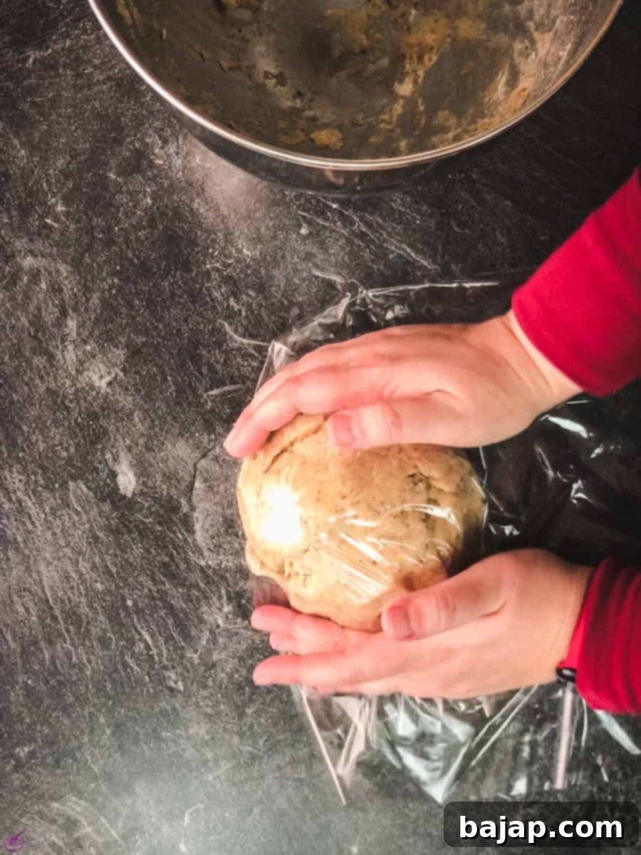 Wrap the vegan cookie dough in cling film and let it chill in the refrigerator for a minimum of 30 minutes to firm up.