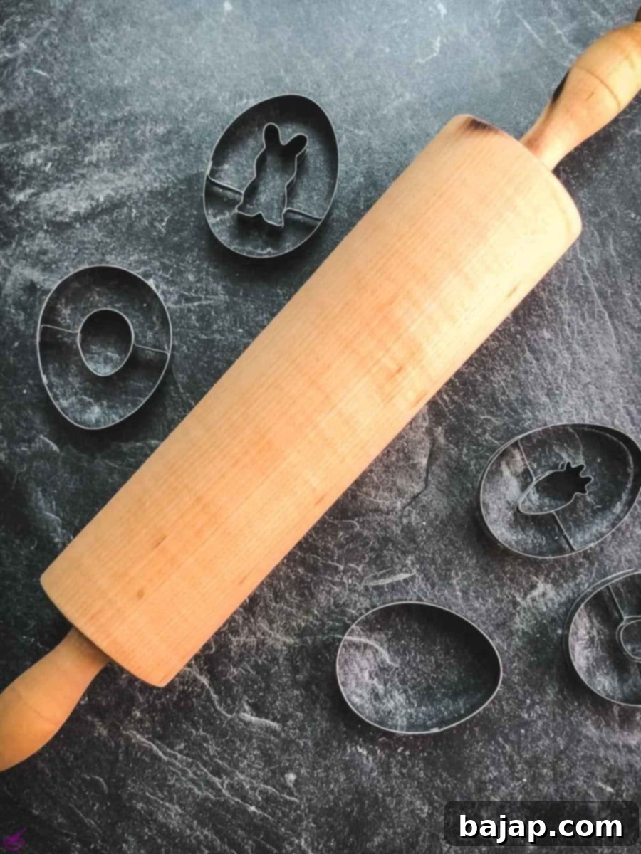 Rolling pin with Easter cut out cookie cutters.