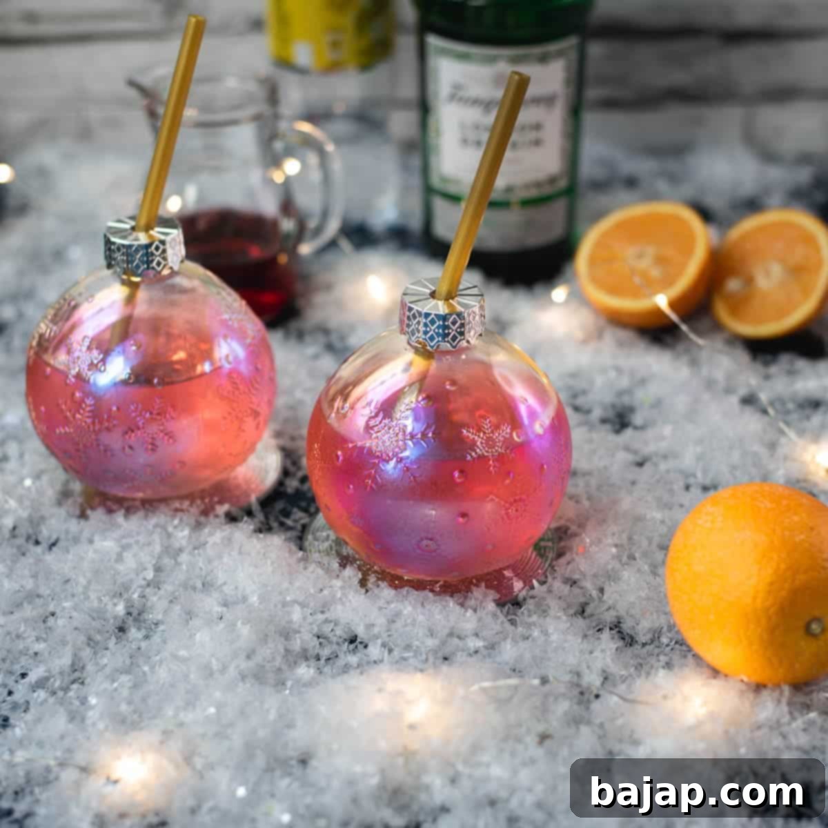 Celebrate National Cocktail Day March 24th 16 Gorgeous Christmas ornament shaped glass filled with festive cranberry gin tonic, placed on glass coaster.