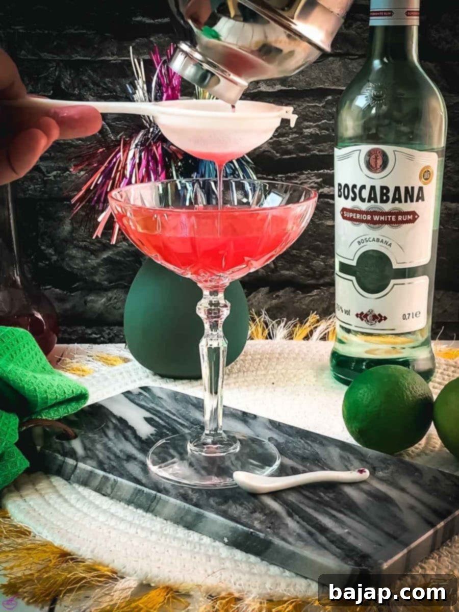 Fine strain the Raspberry Daiquiri into a chilled cocktail glass.