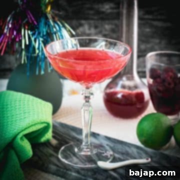Gorgeous raspberry daiquiri with a vibrant red color placed on marble plate.