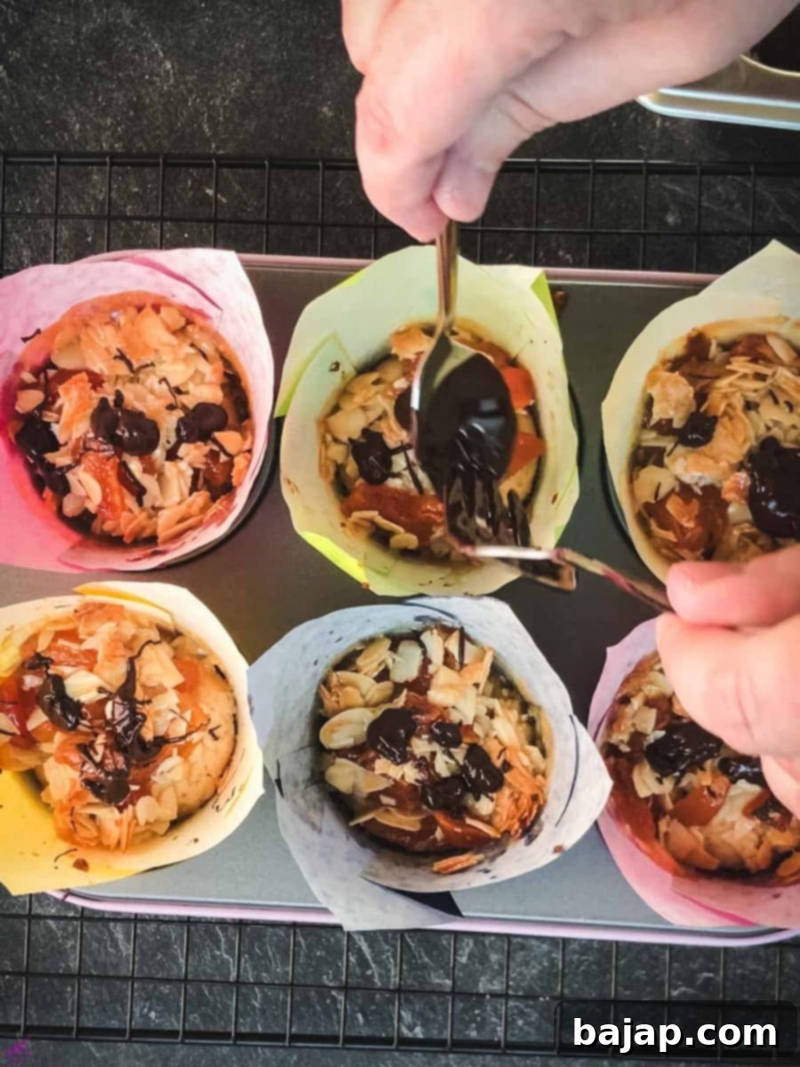 Easy Small Batch Dried Apricot Muffins 12 Delicious dried apricot breakfast muffins, with homemade caramel topping, sprinkled with melted chocolate in muffin rack.