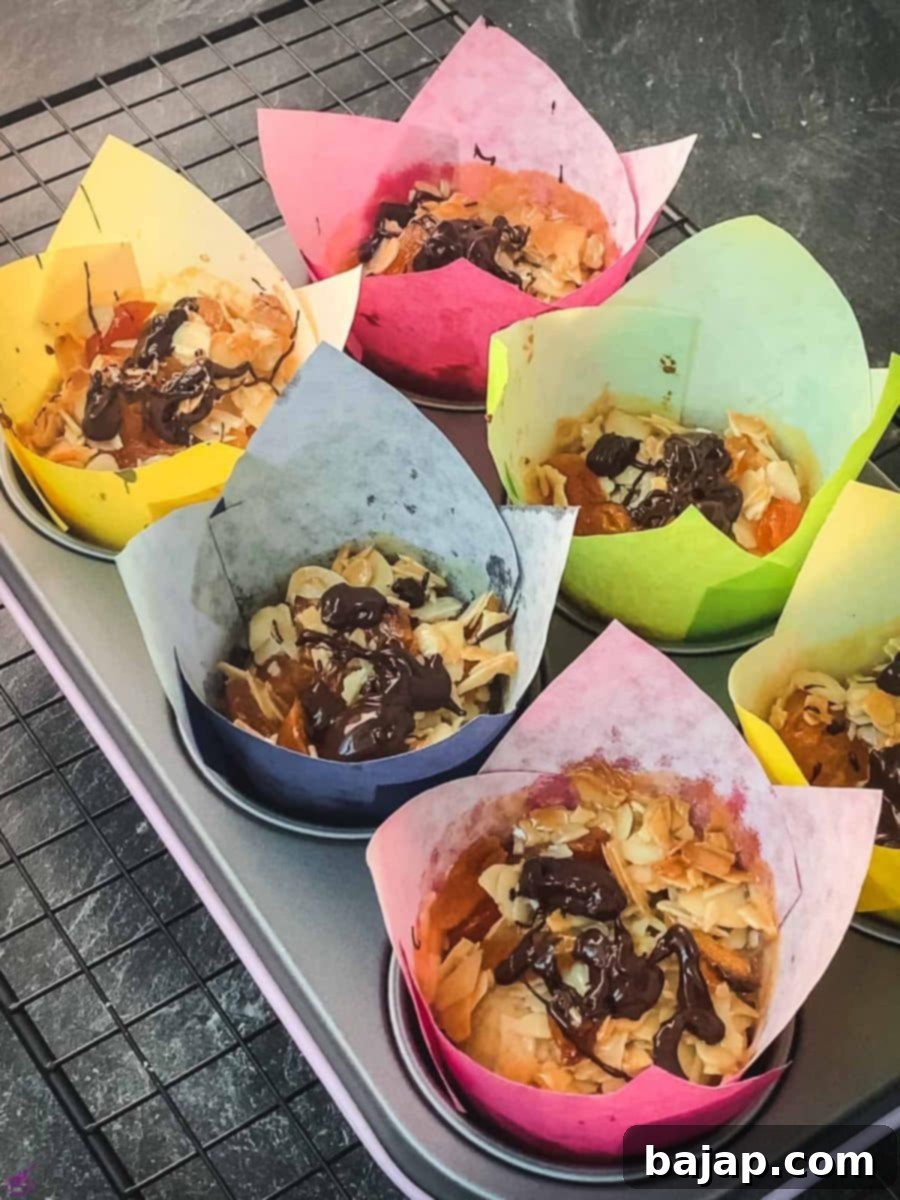 Delicious dried apricot breakfast muffins, with homemade caramel topping, sprinkled with melted chocolate in muffin rack, after baking.