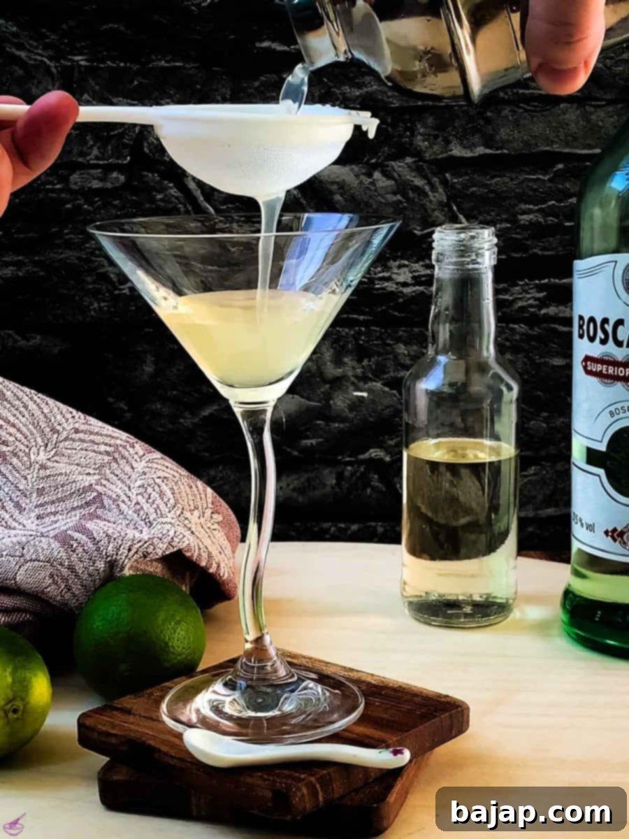 Strain through a fine meshed sieve directly into a cocktail glass. This ensures a smooth, clear drink.
