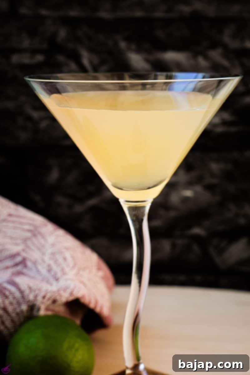 Gorgeous colored daiquiri in cocktail glass. Placed on a wooden board. A perfectly prepared, refreshing daiquiri.