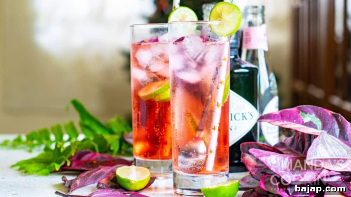 A stunning Pink Gin & Tonic, vibrant in color and beautifully garnished, perfect for any special occasion.
