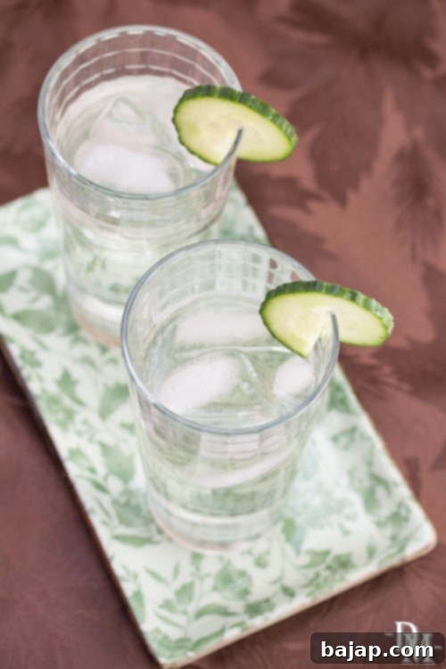 A refreshing herbalist cocktail with intricate garnishes, showcasing a delicate balance of flavors.