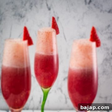 Gorgeous colored champagne flutes filled with vibrant berry mimosa.