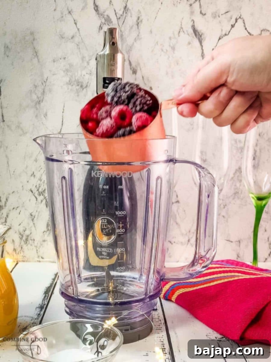 Add the frozen berry mix to the blender, ready for making the mimosa base.
