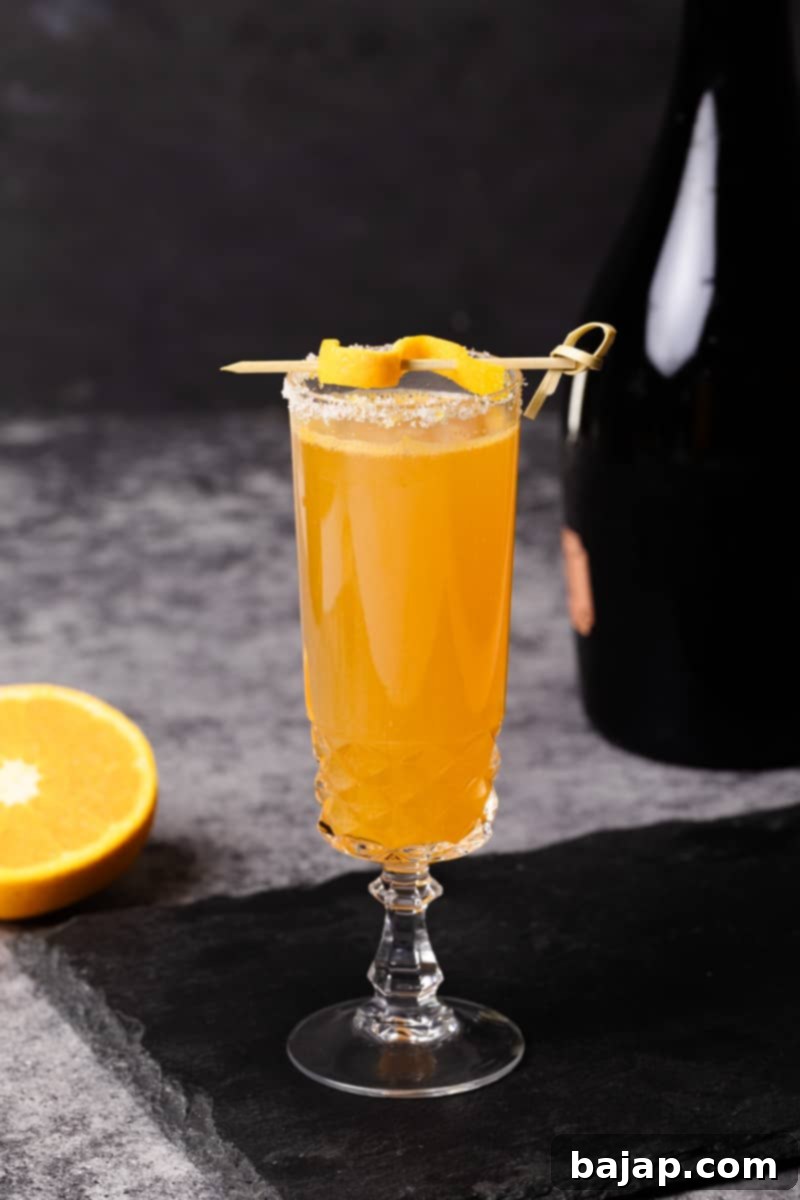 An elegant Rosé Mimosa Cocktail, blending sparkling rosé with fresh orange juice, ideal for holidays or showers.