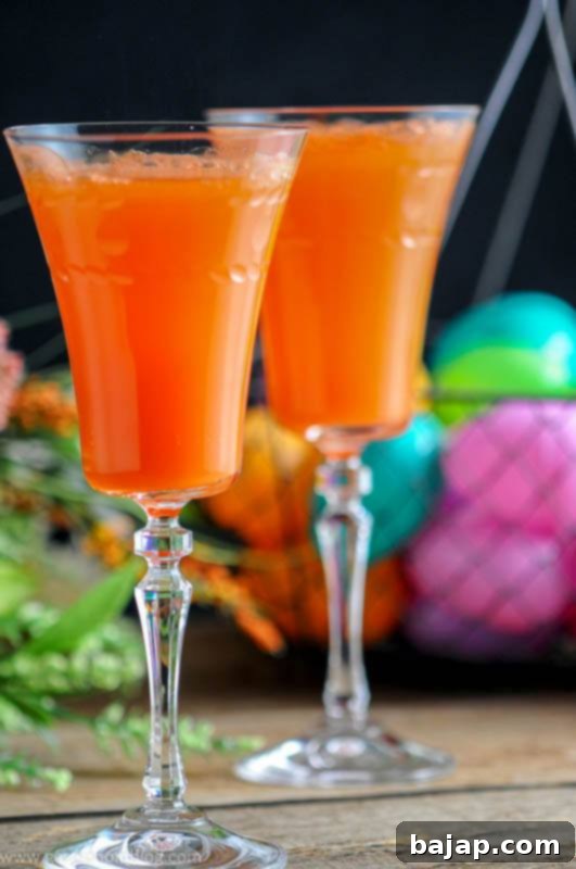 A unique Carrot Ginger Mimosa Cocktail, blending fresh carrot juice, ginger liqueur, and champagne for a spring or summer brunch.