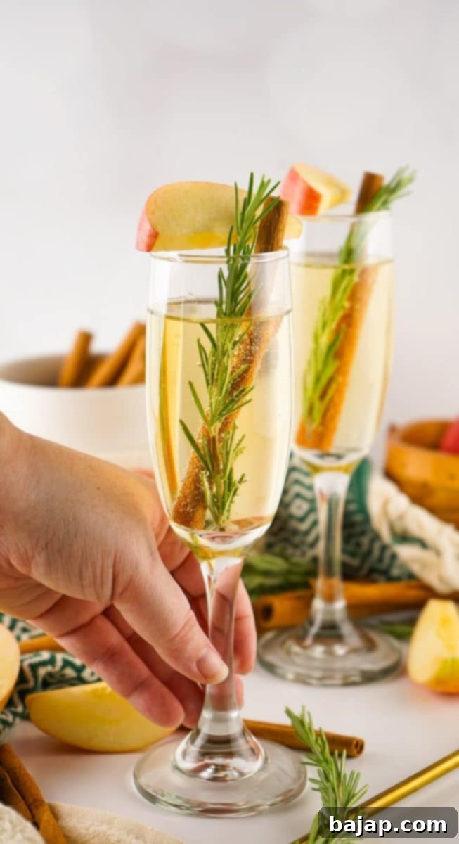 Crisp apple cider mimosa in a flute, garnished with a thin apple slice, offering a perfect, cheerful fall brunch cocktail.