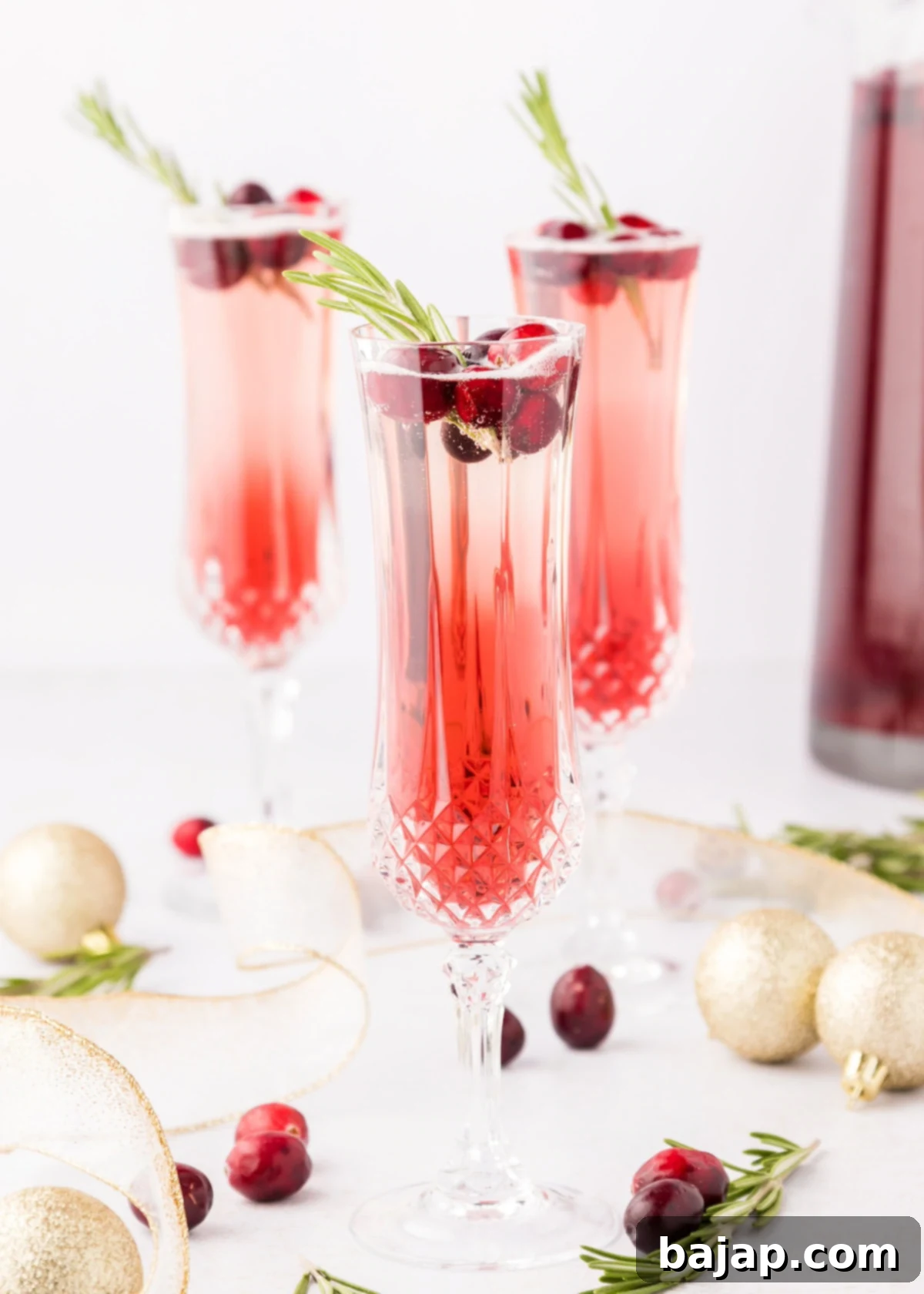 Festive cranberry mimosas or Christmas mimosas in elegant flutes, offering perfect refreshment for any holiday party or gathering.